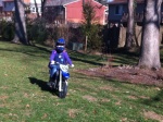 Helen riding her TT-R 50 in her yard