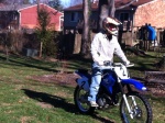 Bill riding his TT-R 230 in his back yard
