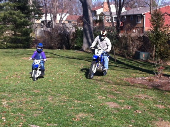 Helen and bill ride their TT-R s in the back yard