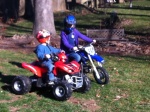 Henry rides his Powerwheels KFX and Helen rides her TT-R 50 in the back yard